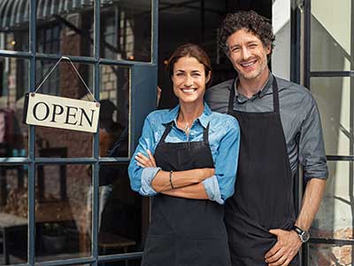 business woman and business man with open sign